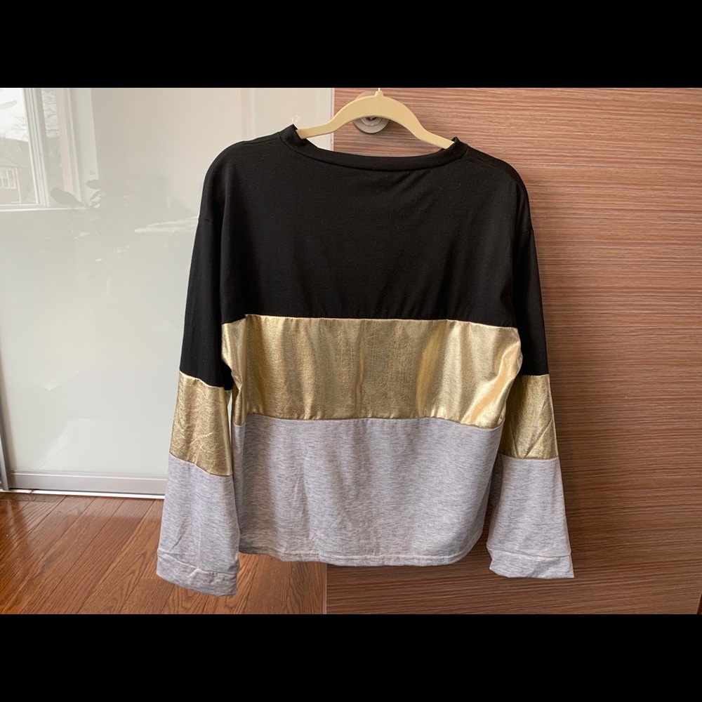 Striped black and gold sweater.